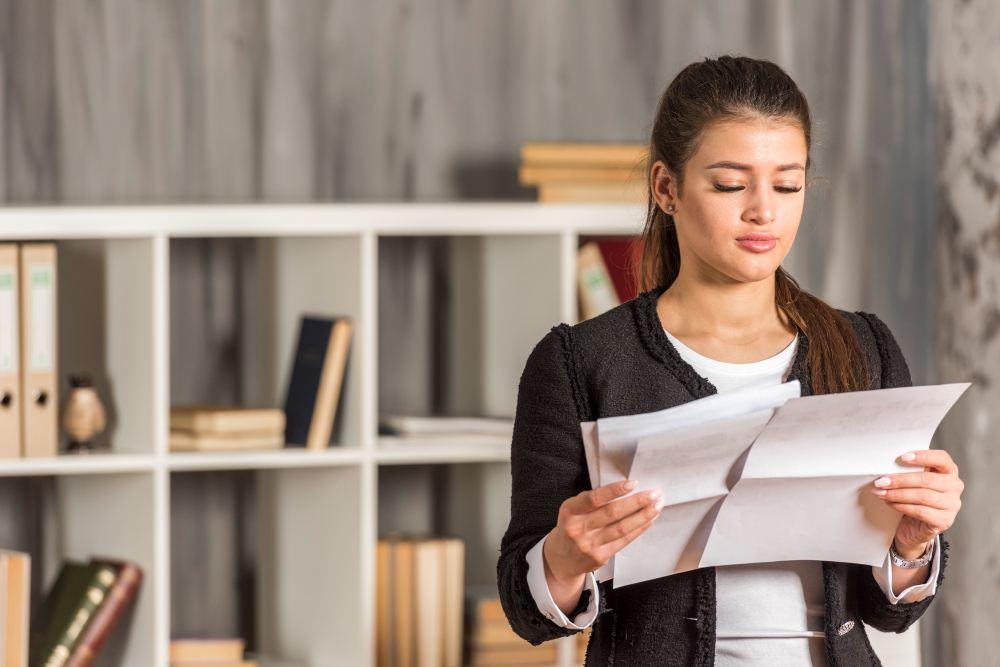 brunette businesswoman reading her office